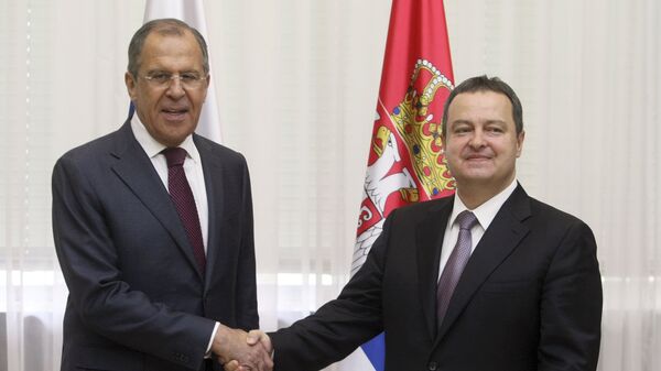Russian Foreign Minister Sergey Lavrov shakes hands with his Serbian counterpart and OSCE Chairperson Ivica Dacic prior to their meeting in Belgrade on May 15, 2015 - Sputnik International