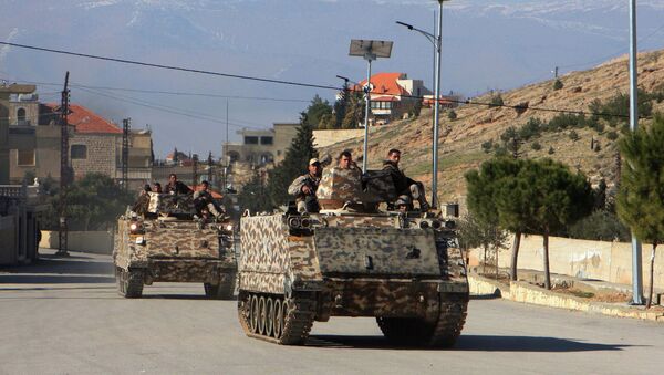 Lebanese army troops drive armoured personnel carriers in the village of Ras Baalbak in the eastern Bekaa Valley near the border with Syria during clashes between Islamist fighters and Lebanese troops. - Sputnik International