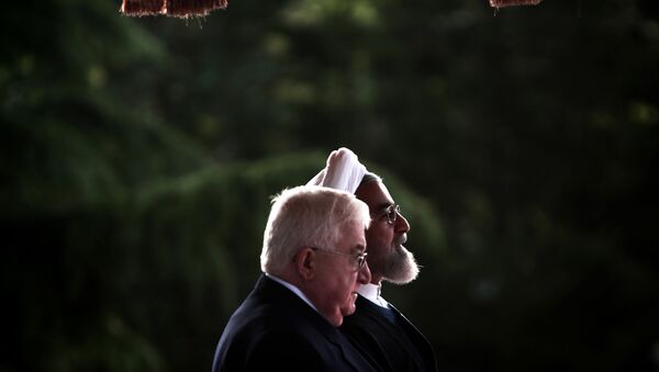 Iranian President Hassan Rouhani (right) listen to the national anthem with his Iraqi counterpart Fuad Masum during the latter's welcoming ceremony at Tehran's Saadabad palace, May 13, 2015 - Sputnik International