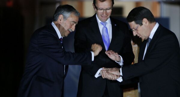 Cyprus' president Nicos Anastasiades, right, Turkish Cypriot leader Mustafa Akinci, left, and United Nations envoy Espen Barth Eide shake hands. Cyprus' president Nicos Anastasiades, right, Turkish Cypriot leader Mustafa Akinci, left, and United Nations envoy Espen Barth Eide shake hands. - Sputnik International