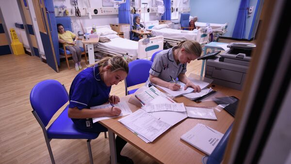 Members of clinical staff complete paperwork in the Accident and Emergency department of the 'Royal Albert Edward Infirmary' in Wigan, north west England on April 2, 2015 - Sputnik International