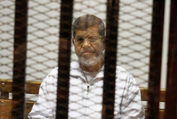 Egypt's ousted Islamist President Mohammed Morsi sits in a defendant cage in the Police Academy courthouse in Cairo, Egypt Egypt's ousted Islamist President Mohammed Morsi sits in a defendant cage in the Police Academy courthouse in Cairo, Egypt - Sputnik International