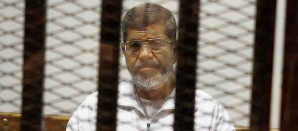 Egypt's ousted Islamist President Mohammed Morsi sits in a defendant cage in the Police Academy courthouse in Cairo, Egypt Egypt's ousted Islamist President Mohammed Morsi sits in a defendant cage in the Police Academy courthouse in Cairo, Egypt - Sputnik International