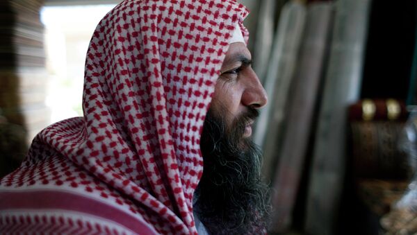 Salafi cleric Mohammed al-Shalabi, 48, widely known as Abu Sayyaf, talks during an interview with the Associated Press at a furniture store, owned by the head of Abu Sayyaf's clan, in the city of Ma'an, Jordan - Sputnik International
