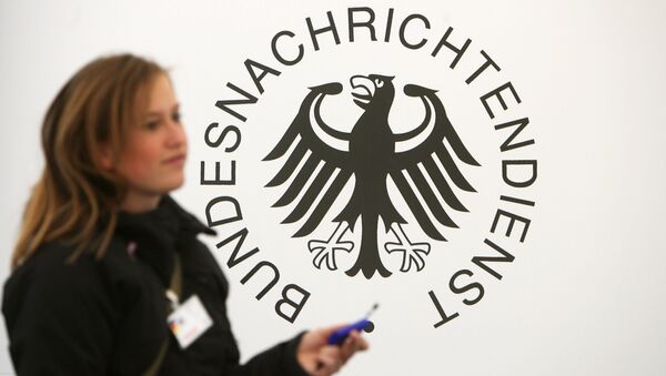 A guest walks past a logo of Germany's intelligence agency the Bundesnachrichtendienst (BND - Federal Intelligence Service) - Sputnik International