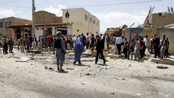 Afghan security forces inspect the site of suicide attack near an international airport in Kabul, Afghanistan, Sunday, May 17, 2015 - Sputnik International