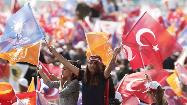 Supporters of Turkey's Prime Minister Ahmet Davutoglu wave Turkish and AK Party flags during an election rally for Turkey's June 7 parliamentary elections in Istanbul, Turkey, May 17, 2015 - Sputnik International