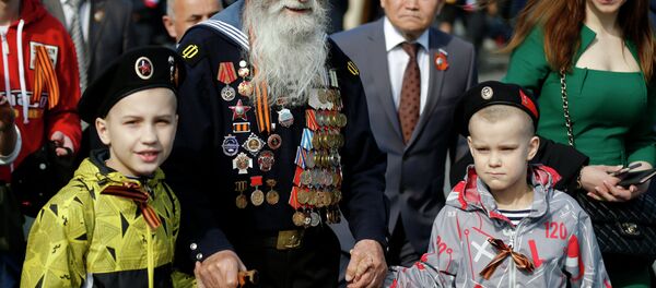 Georgy Shirokov, 91, a Russian veteran of WWII and former sailor of the Baltic Fleet walks in Red Square before the Victory Parade, celebrating 70 years after WWII, in Moscow, Russia, Saturday, May 9, 2015 - Sputnik International