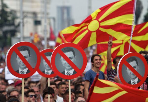 Macedonian protester hold signs with the picture of Macedonia's Prime Minister Nikola Gruevski during an opposition rally in capital Skopje on Sunday, May 17, 2015, demanding his resignation. Macedonian protester hold signs with the picture of Macedonia's Prime Minister Nikola Gruevski during an opposition rally in capital Skopje on Sunday, May 17, 2015, demanding his resignation. - Sputnik International