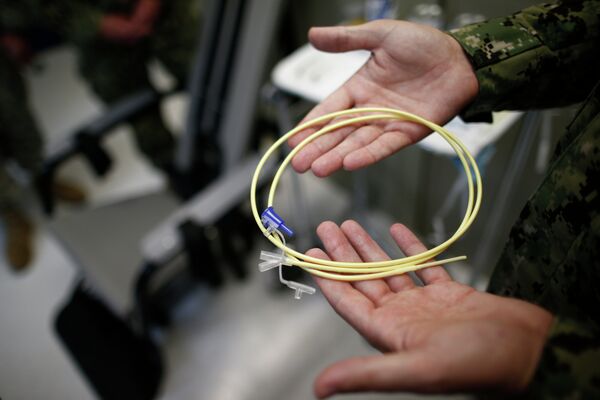 U.S. Navy medical personnel displays an internal feeding tube, used for force-feeding detainees. - Sputnik International