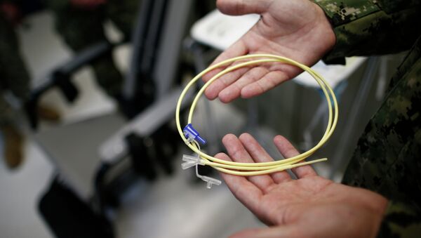 U.S. Navy medical personnel displays an internal feeding tube, used for force-feeding detainees. - Sputnik International