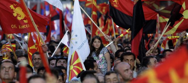 Supporters of the ruling coalition wave national and party flags, during a rally in front of the Parliament building in Skopje, Macedonia, Monday, May 18, 2015 Supporters of the ruling coalition wave national and party flags, during a rally in front of the Parliament building in Skopje, Macedonia, Monday, May 18, 2015 - Sputnik International
