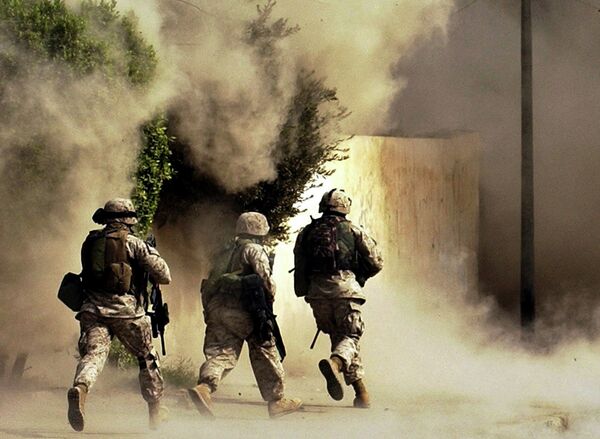US Marines from the 2nd Battalion, 5th Marine Regiment, run to a building after detonating explosives to open a gate during a mission in Ramadi in Anbar province, Iraq US Marines from the 2nd Battalion, 5th Marine Regiment, run to a building after detonating explosives to open a gate during a mission in Ramadi in Anbar province, Iraq - Sputnik International