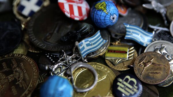A badge with the Greek flag, center, and other badges and pins. - Sputnik International