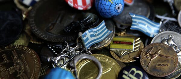 A badge with the Greek flag, center, and other badges and pins. - Sputnik International