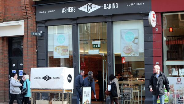 Pedestrians and customers walk by a branch of Ashers Baking Company in Belfast - Sputnik International