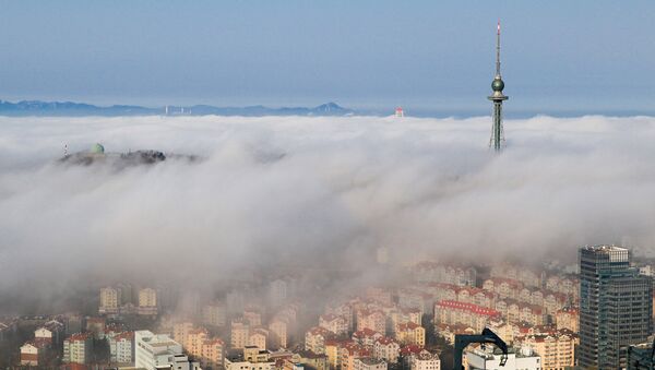 Residential buildings are seen among fog in Qingdao, Shandong province, China - Sputnik International