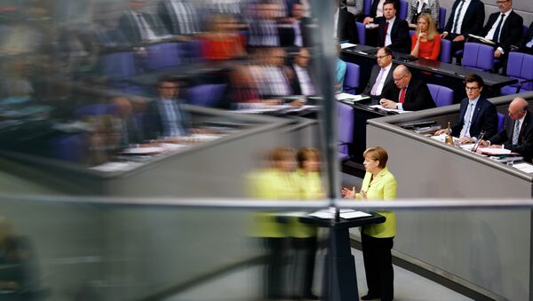 German Chancellor Angela Merkel is reflected in a window pane as she delivers a government declaration about the European Union and an Eastern Partnership with former Soviet Republics at the German parliament Bundestag in Berlin, Germany, Thursday, May 21, 2015. - Sputnik International