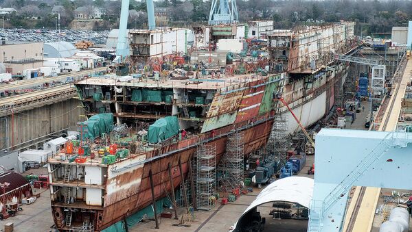 The USS Ford - seen here under construction in 2012 - ran $2 billion over budget but the Navy promised most of those costs were due to its being the first of its class and would not recur with the USS Kennedy. - Sputnik International