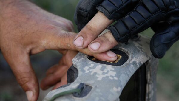 A US soldier records finger prints of a man while on patrol in Afghanistan. - Sputnik International