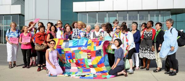 Female activists from around the world arrive at Pyongyang airport in Pyongyang, North Korea, in this photo taken and released by Kyodo May 19, 2015 - Sputnik International