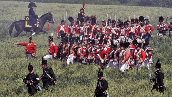 People in period uniforms fight during a re-enactment of the 1815 Battle of Waterloo between the French army led by Napoleon and the Allied armies led by the Duke of Wellington and Field-Marshal Blucher, on June 17, 2012, in Waterloo - Sputnik International