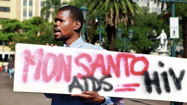 An activist carries a sign during a protest against chemical giant Monsanto in Durban on May 24, 2014 - Sputnik International