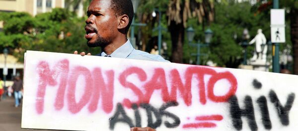 An activist carries a sign during a protest against chemical giant Monsanto in Durban on May 24, 2014 An activist carries a sign during a protest against chemical giant Monsanto in Durban on May 24, 2014 - Sputnik International