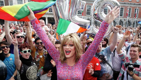 Rory O'Neill, known by the Drag persona Panti, celebrates with yes supporters at Dublin Castle, Ireland, Saturday, May 23, 2015. Ireland has voted resoundingly to legalize gay marriage in the world's first national vote on the issue, leaders on both sides of the Irish referendum declared Saturday even as official ballot counting continued. Senior figures from the no campaign, who sought to prevent Ireland's constitution from being amended to permit same-sex marriages, say the only question is how large the yes side's margin of victory will be from Friday's vote. - Sputnik International