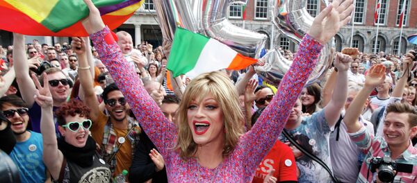 Rory O'Neill, known by the Drag persona Panti, celebrates with yes supporters at Dublin Castle, Ireland, Saturday, May 23, 2015. Ireland has voted resoundingly to legalize gay marriage in the world's first national vote on the issue, leaders on both sides of the Irish referendum declared Saturday even as official ballot counting continued. Senior figures from the no campaign, who sought to prevent Ireland's constitution from being amended to permit same-sex marriages, say the only question is how large the yes side's margin of victory will be from Friday's vote. - Sputnik International