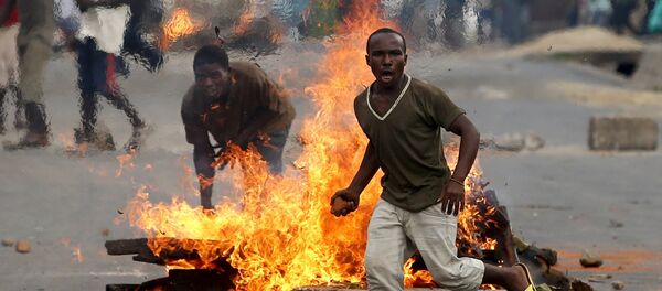 File Photo: A protester runs in front of a burning barricade during a protest against Burundi President Pierre Nkurunziza and his bid for a third term in Bujumbura, Burundi, May 21, 2015 File Photo: A protester runs in front of a burning barricade during a protest against Burundi President Pierre Nkurunziza and his bid for a third term in Bujumbura, Burundi, May 21, 2015 - Sputnik International