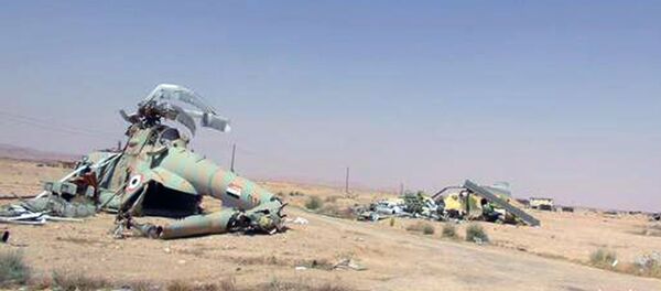 This picture released on Thursday, May 21, 2015 by the website of Islamic State militants, shows damaged Syrian military helicopters at Palmyra air base that was captured by the Islamic State militants after a battle with the Syrian government forces in Palmyra, Syria - Sputnik International