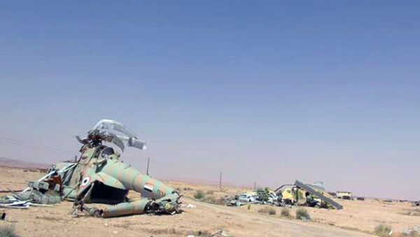 This picture released on Thursday, May 21, 2015 by the website of Islamic State militants, shows damaged Syrian military helicopters at Palmyra air base that was captured by the Islamic State militants after a battle with the Syrian government forces in Palmyra, Syria - Sputnik International