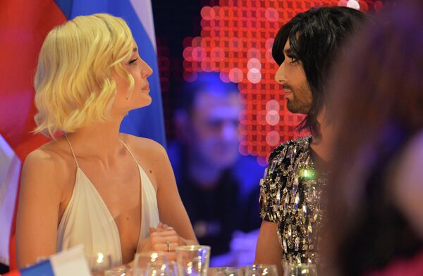 Conchita Wurst, who won the 2014 ESC for Austria, right, talks to Polina Gagarina representing Russia during the final of the Eurovision Song Contest in Austria's capital Vienna, Sunday, May 24, 2015 Conchita Wurst, who won the 2014 ESC for Austria, right, talks to Polina Gagarina representing Russia during the final of the Eurovision Song Contest in Austria's capital Vienna, Sunday, May 24, 2015 - Sputnik International
