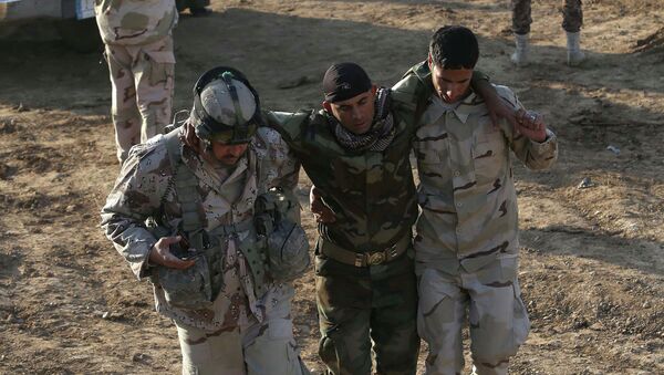 Iraqi soldiers help a wounded comrade in the area of Sayed Ghareeb, near Dujail, some 70 kilometres north of Baghdad - Sputnik International