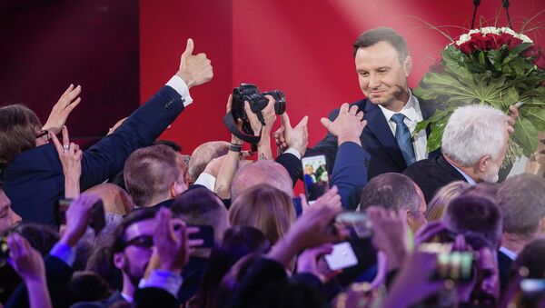 Andrzej Duda (R), presidential candidate of Law and Justice (PiS) right wing opposition party celebrates after the announcement of the exit poll results of the second round of the presidential election in Warsaw, on May 24, 2015 - Sputnik International