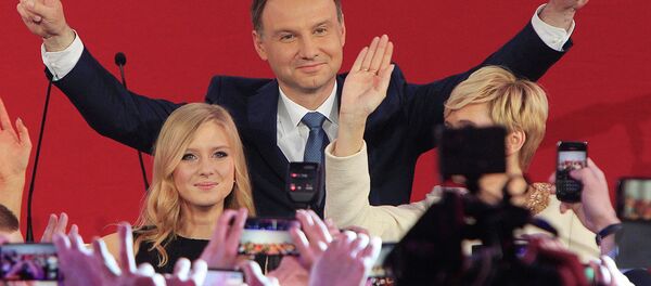Opposition candidate Andrzej Duda, with daughter Kinga greet supporters as first exit polls in the presidential runoff voting are announced, in Warsaw, Poland, Sunday, May 24, 2015 Opposition candidate Andrzej Duda, with daughter Kinga greet supporters as first exit polls in the presidential runoff voting are announced, in Warsaw, Poland, Sunday, May 24, 2015 - Sputnik International