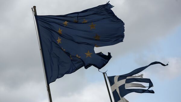 Ruined EU and Greek flags fly in tatters from a flag pole at a beach at Anavissos village, southwest of Athens, on Monday, March 16, 2015 - Sputnik International