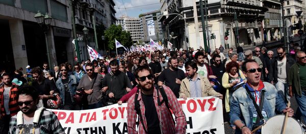 Communist affiliated protesters march in central Athens during a massive protest rally against unemployment and the austerity measures on October 4, 2014 Communist affiliated protesters march in central Athens during a massive protest rally against unemployment and the austerity measures on October 4, 2014 - Sputnik International