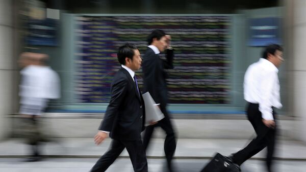 People walk past an electronic stock board of a securities firm in Tokyo. - Sputnik International