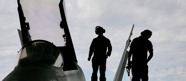 US Marines work atop an F/A-18 at the 309th Aerospace Maintenance and Regeneration Group boneyard in Tucson, Ariz US Marines work atop an F/A-18 at the 309th Aerospace Maintenance and Regeneration Group boneyard in Tucson, Ariz - Sputnik International
