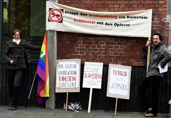 Protestors hold a banner reading Stop the drone war via Ramstein, solidarity with the victims Protestors hold a banner reading Stop the drone war via Ramstein, solidarity with the victims - Sputnik International