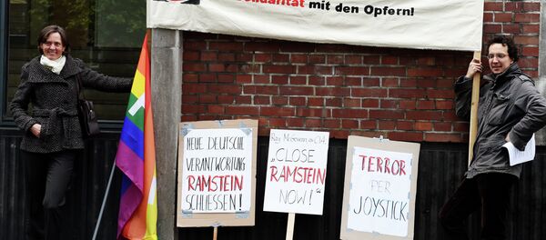Protestors hold a banner reading Stop the drone war via Ramstein, solidarity with the victims Protestors hold a banner reading Stop the drone war via Ramstein, solidarity with the victims - Sputnik International