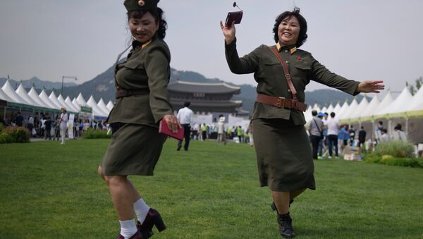 North Korean defectors wearing North Korean military uniforms dance in Gwanghwamun square during a 'unification expo' in central Seoul on May 29, 2015 - Sputnik International