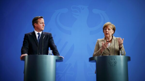 German Chancellor Angela Merkel and Britian's Prime Minister David Cameron address a joint news conference following a meeting at the Chancllery in Berlin, Germany - Sputnik International
