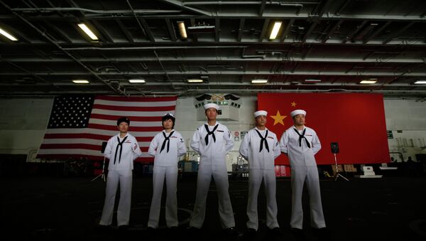 Chinese-American Navy sailors stand in front of the China's and American national flags on the aircraft carrier USS George Washington. - Sputnik International