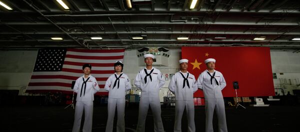 Chinese-American Navy sailors stand in front of the China's and American national flags on the aircraft carrier USS George Washington in Hong Kong Wednesday Nov. 9, 2011. Chinese-American Navy sailors stand in front of the China's and American national flags on the aircraft carrier USS George Washington in Hong Kong Wednesday Nov. 9, 2011. - Sputnik International