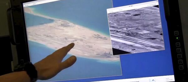 US Navy crewman aboard a P-8A Poseidon surveillance aircraft points to a computer screen purportedly showing Chinese construction on the reclaimed land of Fiery Cross Reef in the disputed Spratly Islands in the South China Sea in this still image from video provided by the United States Navy May 21, 2015 US Navy crewman aboard a P-8A Poseidon surveillance aircraft points to a computer screen purportedly showing Chinese construction on the reclaimed land of Fiery Cross Reef in the disputed Spratly Islands in the South China Sea in this still image from video provided by the United States Navy May 21, 2015 - Sputnik International