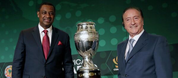 CONCACAF president Jeffrey Webb, left, and Eugenio Figueredo, right, president of CONMEBOL, the South American scoccer Confederation, pose for photographers next to the 2016 Copa America trophy in Bal Harbour, Fla - Sputnik International