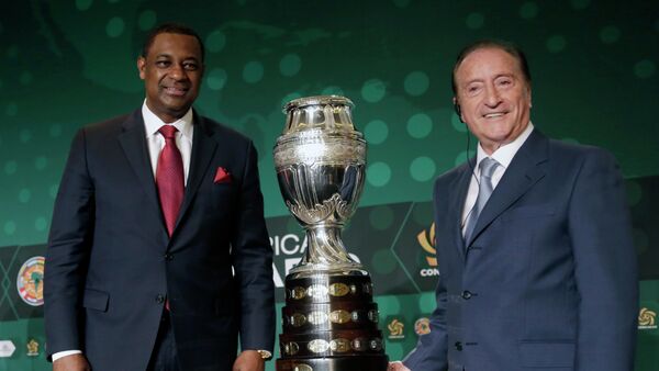 CONCACAF president Jeffrey Webb, left, and Eugenio Figueredo, right, president of CONMEBOL, the South American scoccer Confederation, pose for photographers next to the 2016 Copa America trophy in Bal Harbour, Fla - Sputnik International
